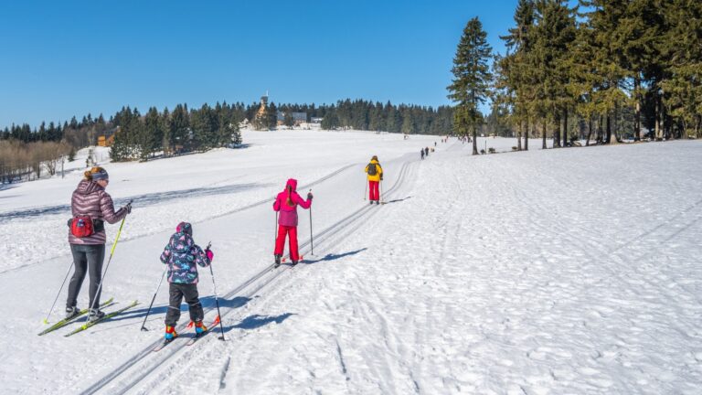 Family on cross-country skiing trails in Norway.
