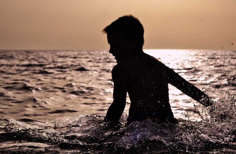 Norwegian boy playing in the ocean.