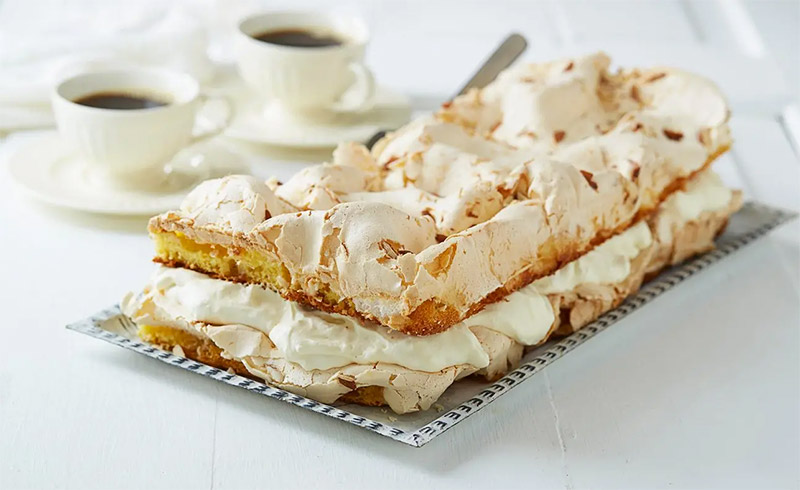A Kvæfjordkake in Norway with a cup of coffee.