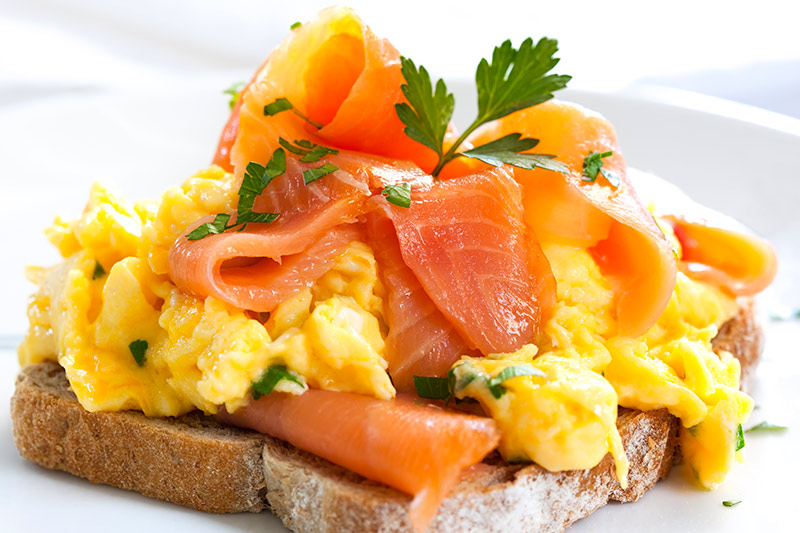 A scrambled egg and smoked salmon sandwich.