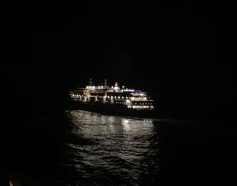 The Hurtigruten ship MS Kong Harald passing us by outside Berlevåg in northern Norway