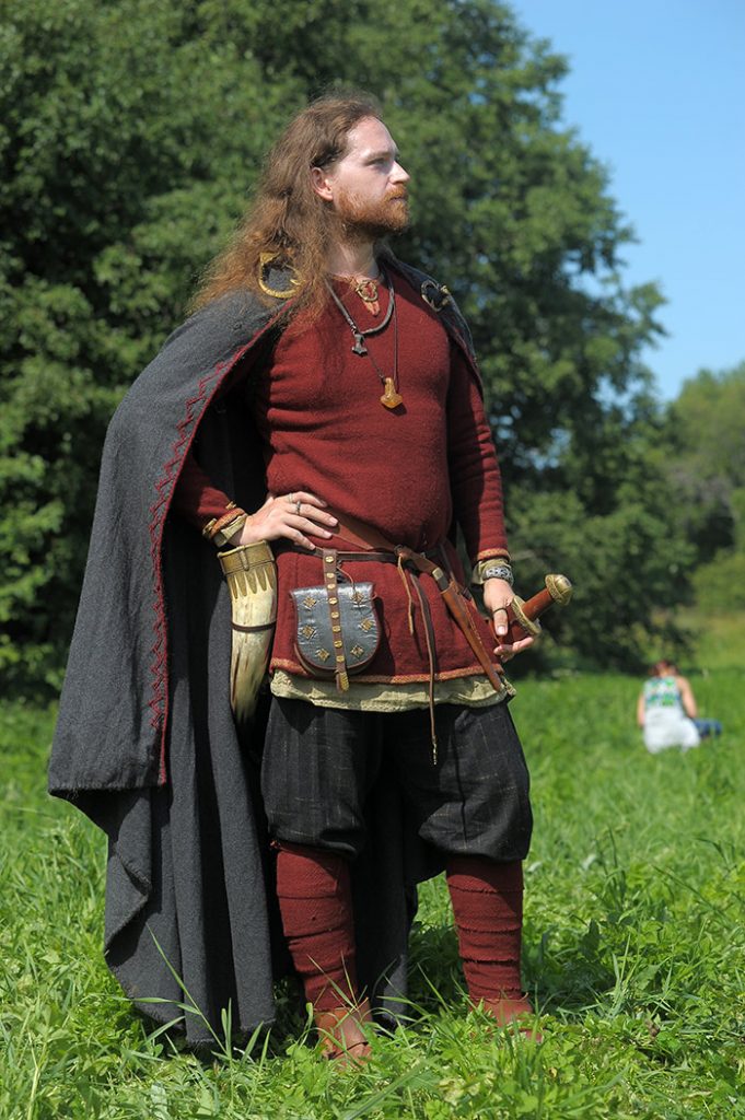 A man wearing a costume at a viking reenactment.