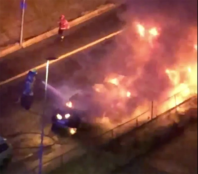 Emergency services tackling a car fire in Oslo, Norway