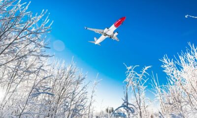Norwegian 737-800 airline in the sky on a snowy day