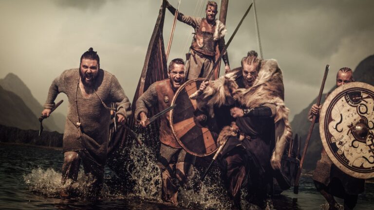 Viking warriors arriving by ship.