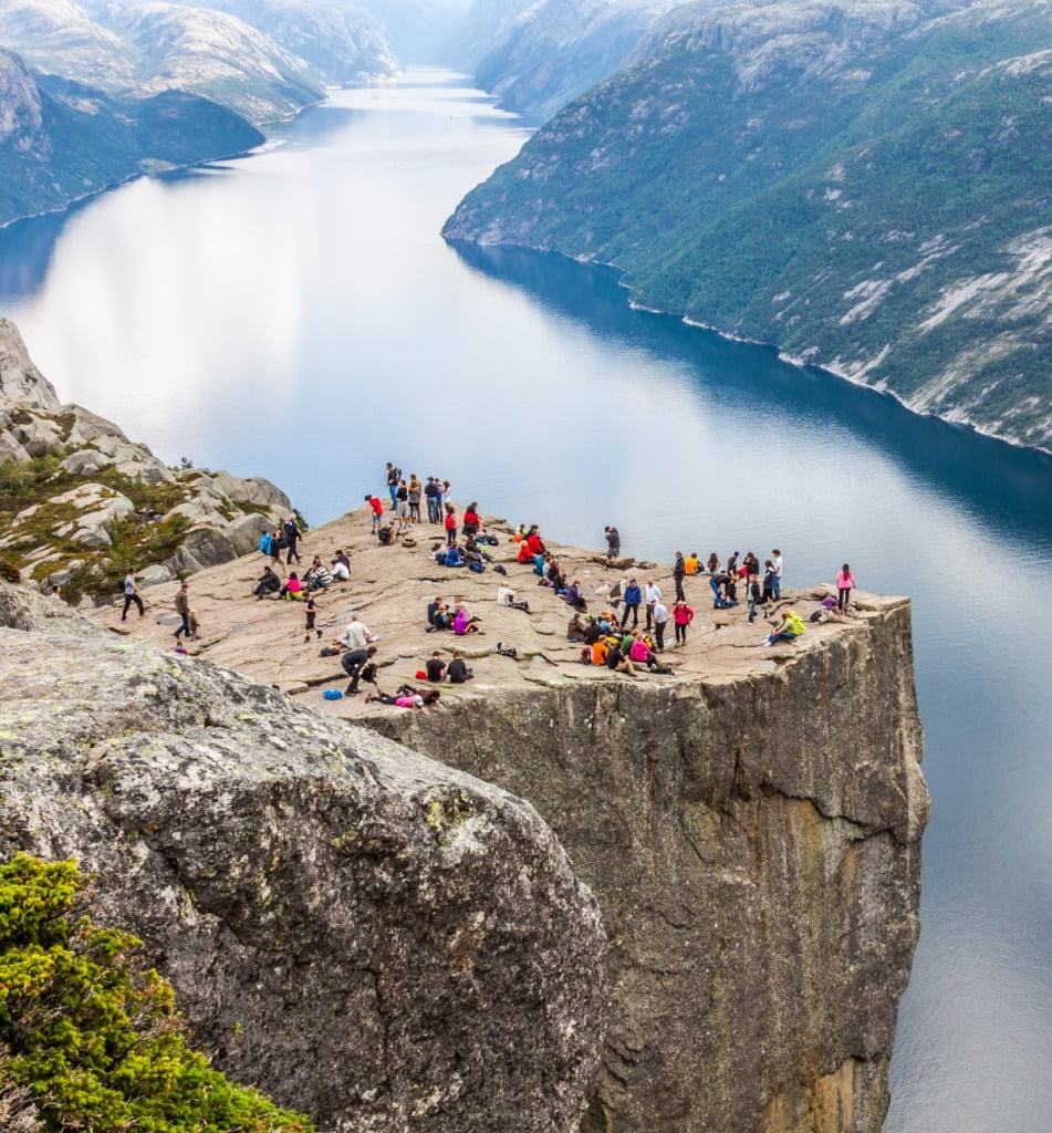 People gather on Pulpit Rock looking at the Lysefjord.