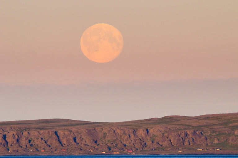 A full moon in the midnight sun over Varangerhalvøya National Park