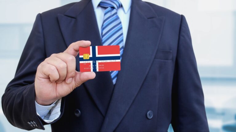 Businessman holding a Norway credit card.
