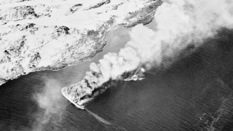 The German-controlled prisoner ship Rigel and a small V-boat escort burning after being bombed and strafed by British aircraft. Photo: Royal Navy / Public Domain.