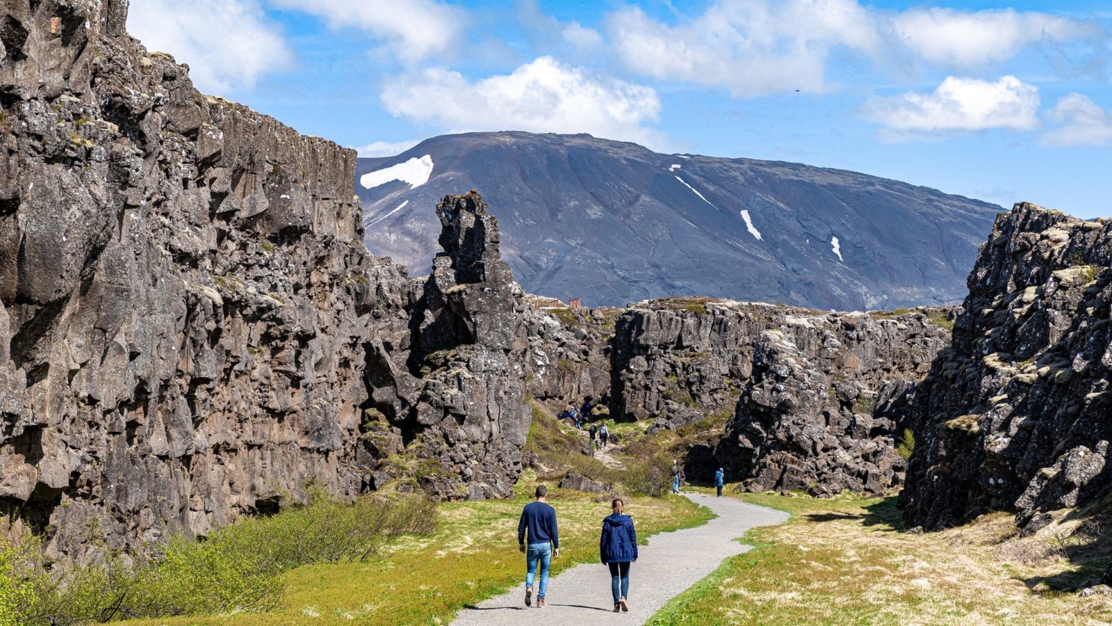 A couple of tourists walking in Thingvellir National Park, Iceland.