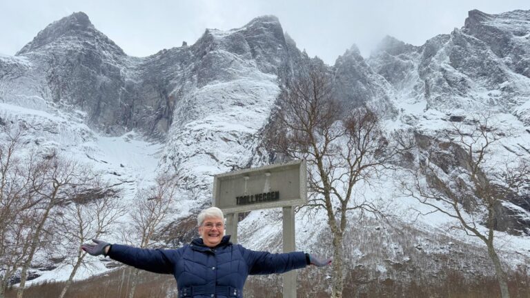 Woman standing in front of Trollveggen in Norway. Photo: David Nikel.